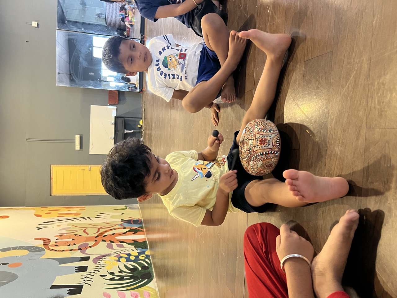A child playing a hand drum during a music and movement session